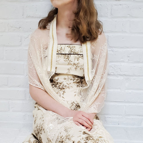 Eggnog ladies tallit in sheer patterned lace with a hint of stretch. Adorned with Venetian fringe trim and a gold-accented atarah.