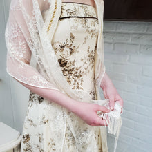 A girl handles the tactile tzitzit and Venetian fringe on a handmade lace tallit.